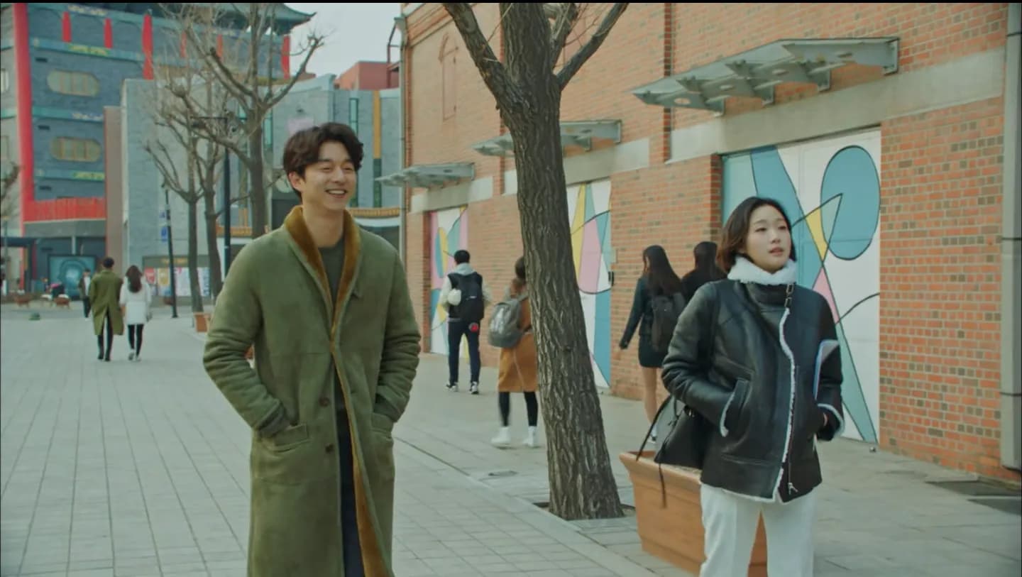 Brick warehouse facade with the two characters walking