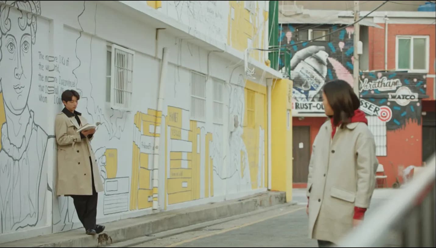 Pastel mural alley in Songwol-dong with the two characters walking