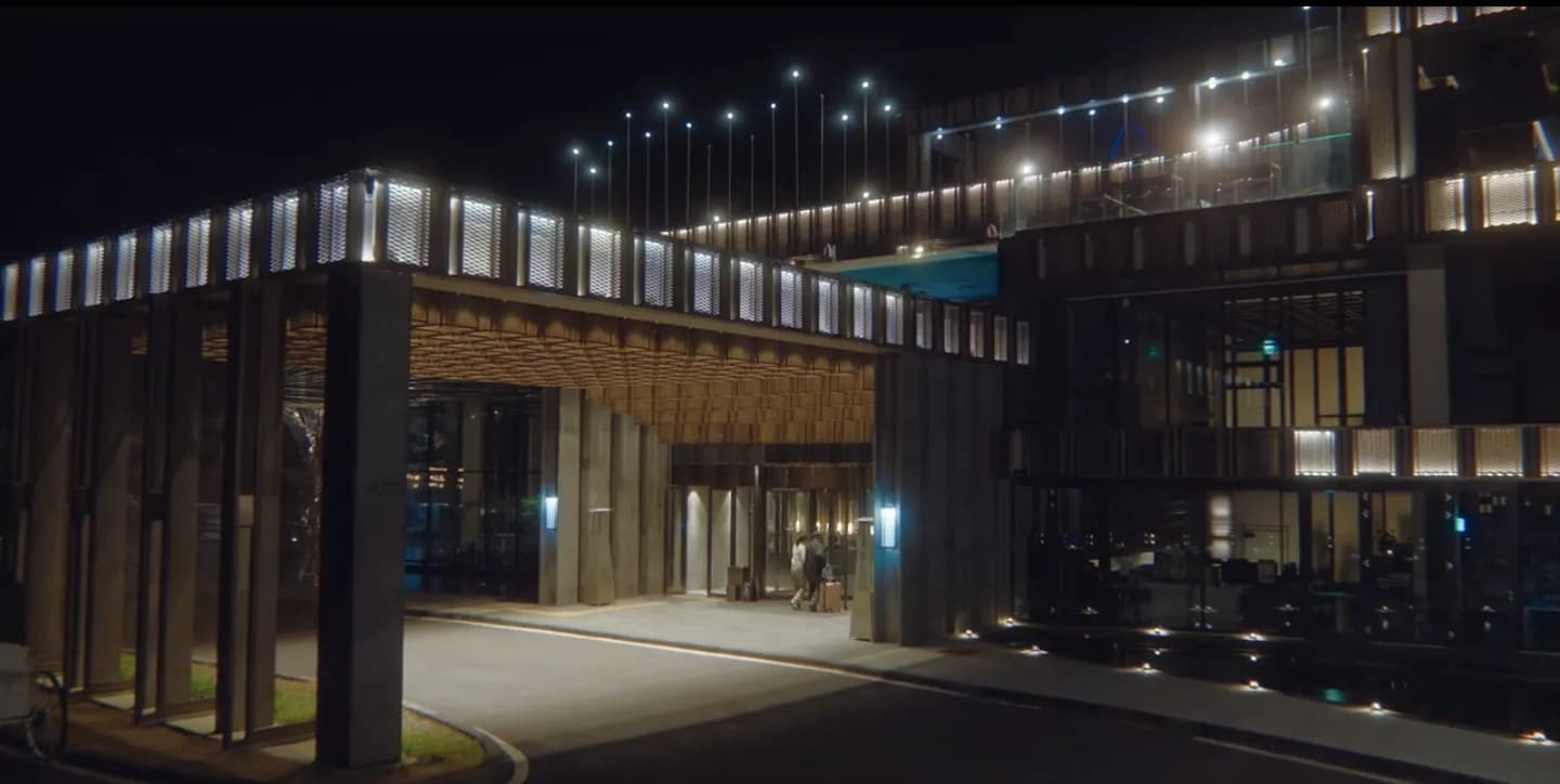 The illuminated facade of Amber Pure Hill resort at night on Jeju