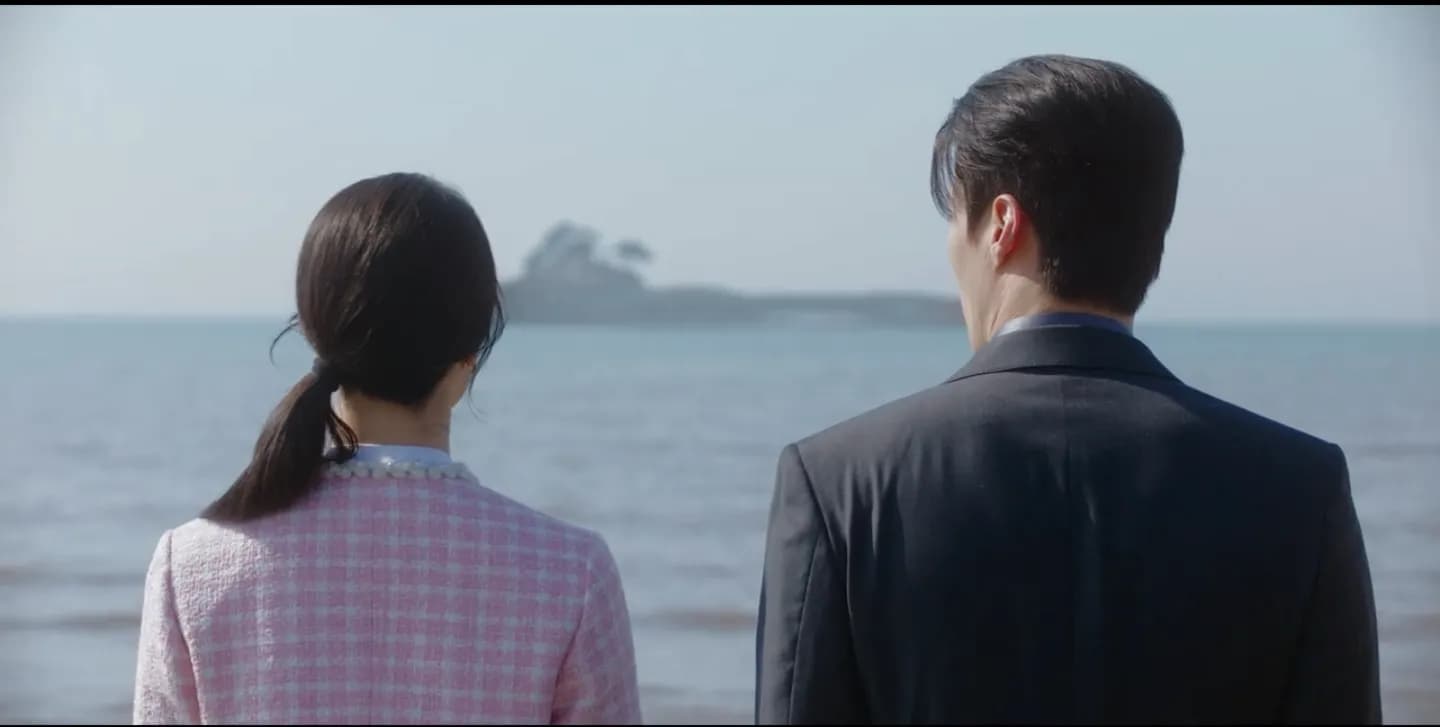 Se-gye and Seo-ri gazing at a wooded islet across the sea