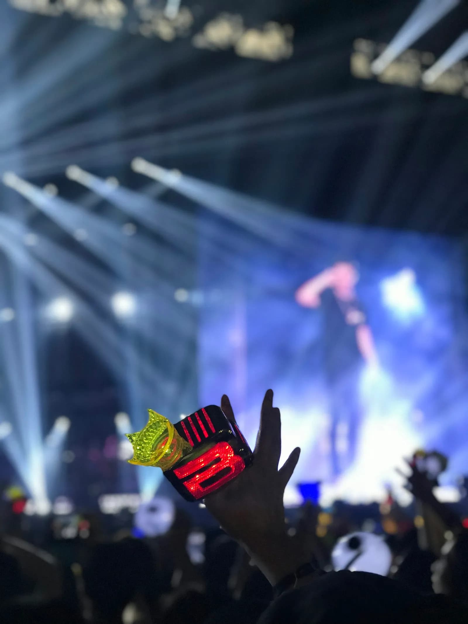 Vertical view of K-pop concert hall lit up with thousands of lightsticks