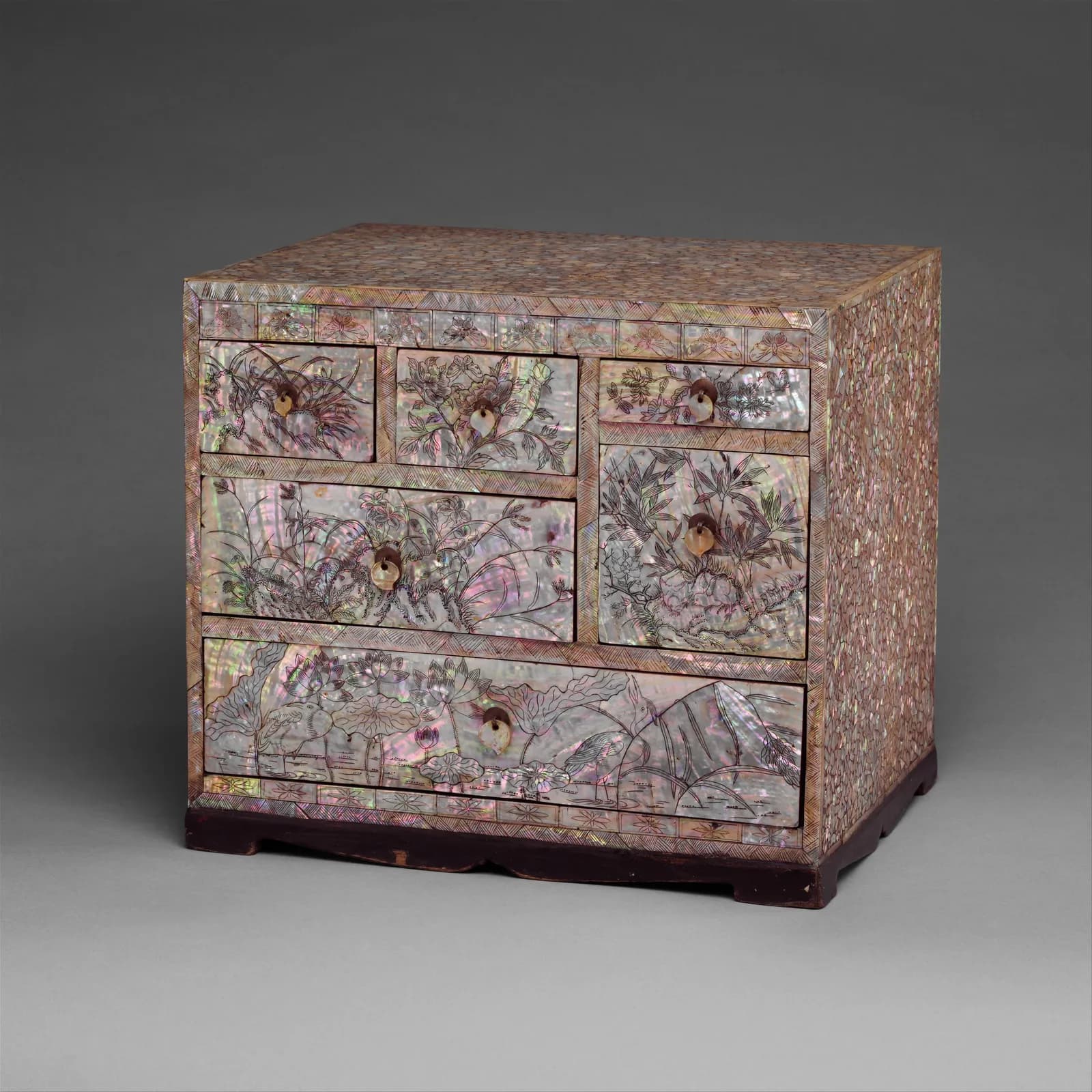 Small chest of drawers shimmering with mother-of-pearl flowers and birds