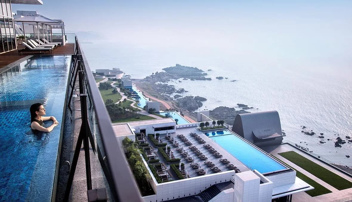 Ananti at Busan Cove infinity pool overlooking the Gijang Sea coastline at sunrise