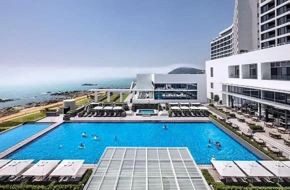 Ananti at Busan Cove outdoor pool deck with cabanas and ocean view