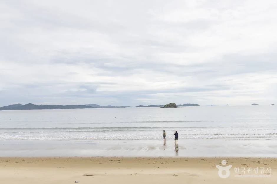 Calm water and an offshore islet at Baekgil Beach, Sinan