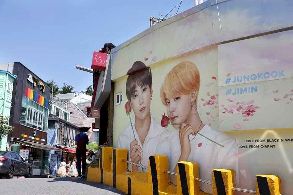 Commissioned mural of BTS Jungkook and Jimin holding roses, painted on a wall near the Hanji Workshop inside Gamcheon Culture Village