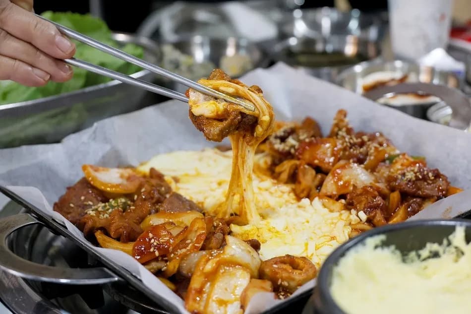 Briquette-grilled galbi with mozzarella cheese, the signature dish at Gopchang Salon