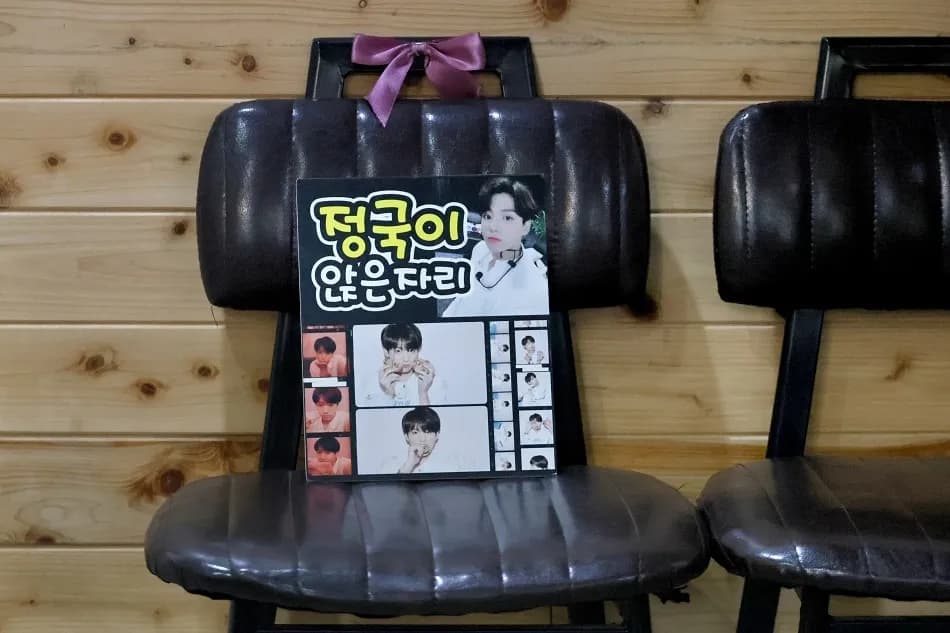 Marked chair labeled 'Jungkook's seat' at Gopchang Salon in Busanjin-gu