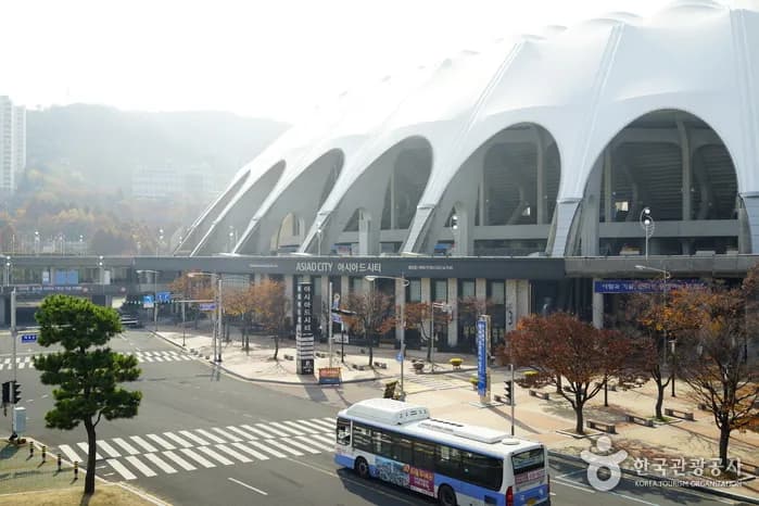 Busan Asiad Main Stadium exterior with curved wave-inspired roof