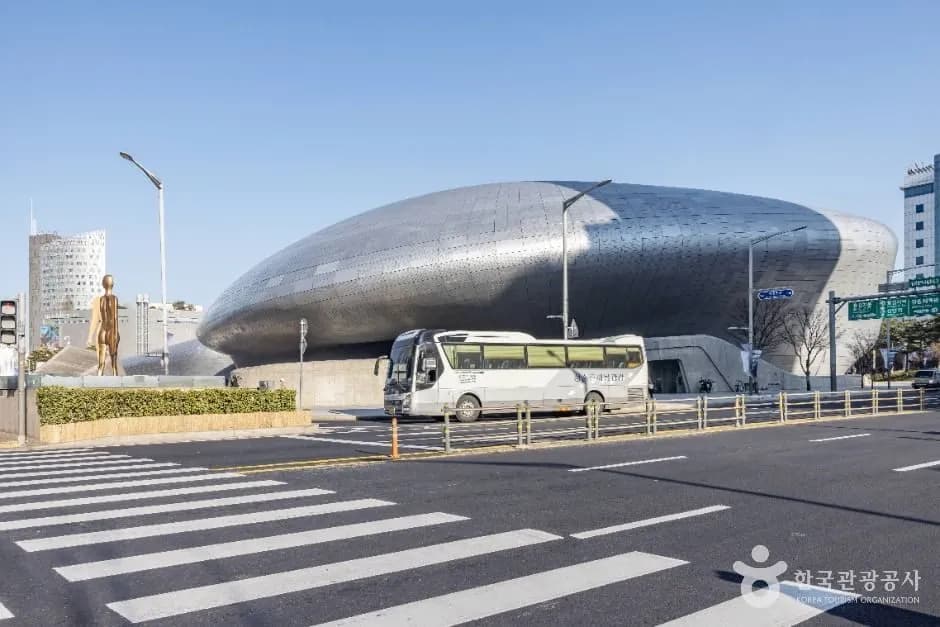 Dongdaemun Design Plaza illuminated at night with its curved architecture
