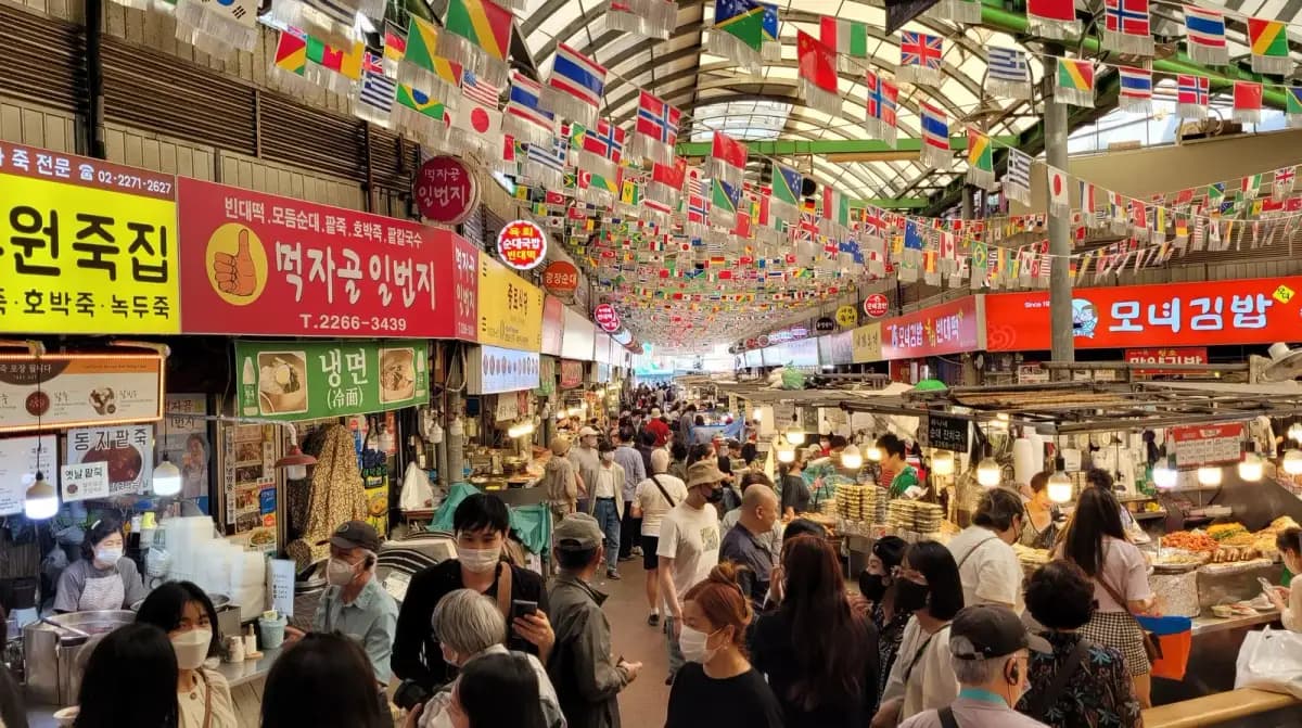 Gwangjang Market food stalls with vendors cooking Korean street food