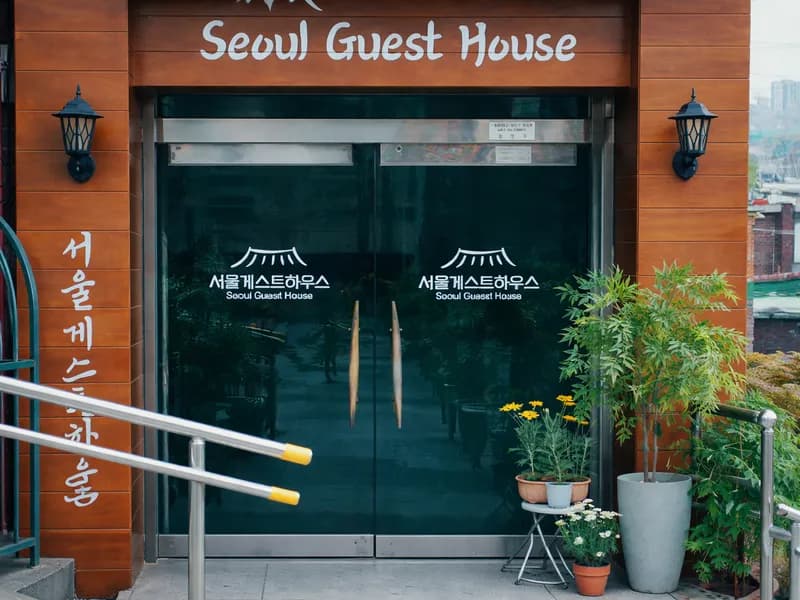 Seoul Guest House entrance with wooden sign on Duteopbawi-ro 58-gil, Yongsan-gu