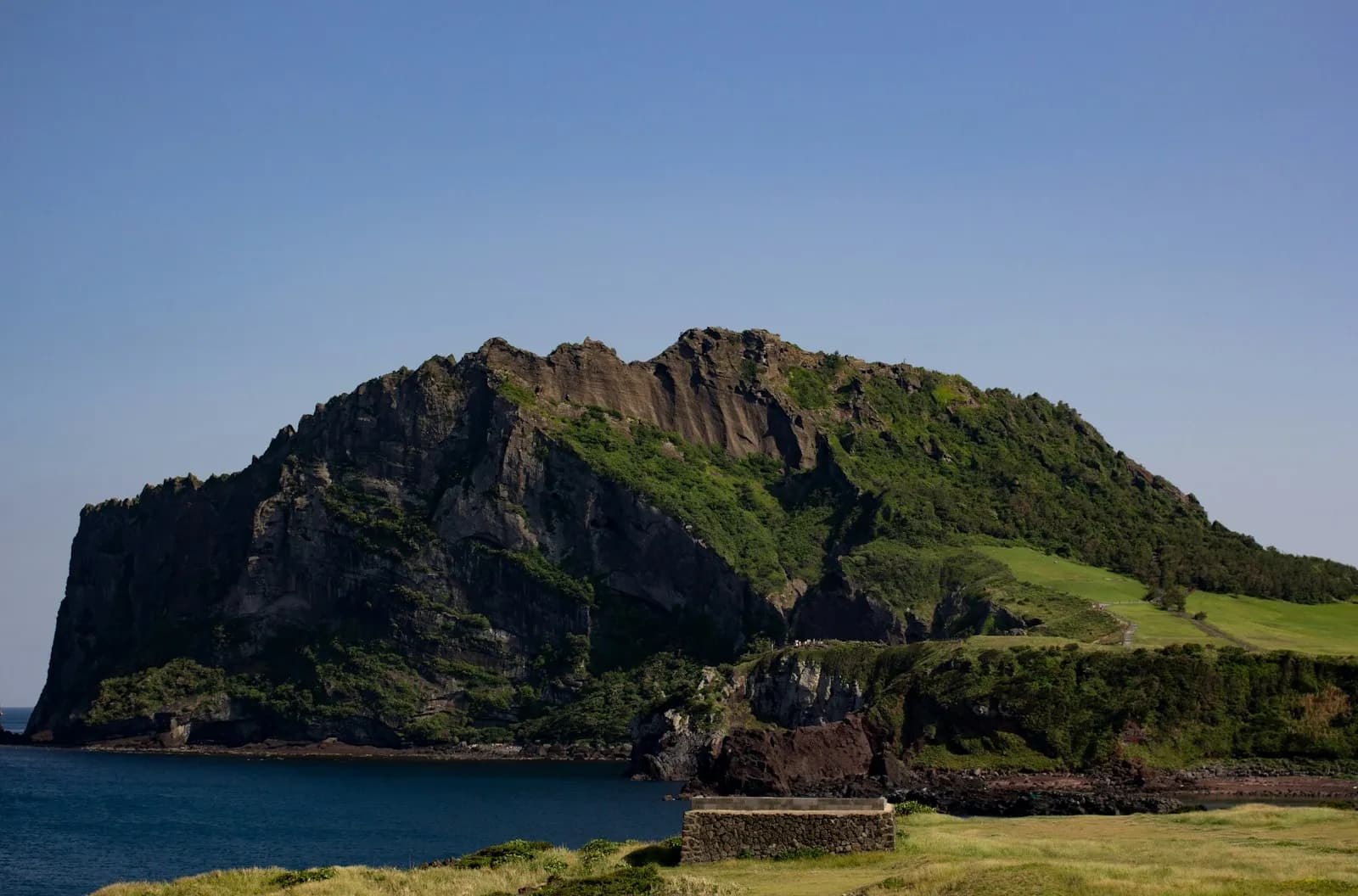 Seongsan Ilchulbong volcanic peak rising from the coastline of Jeju Island
