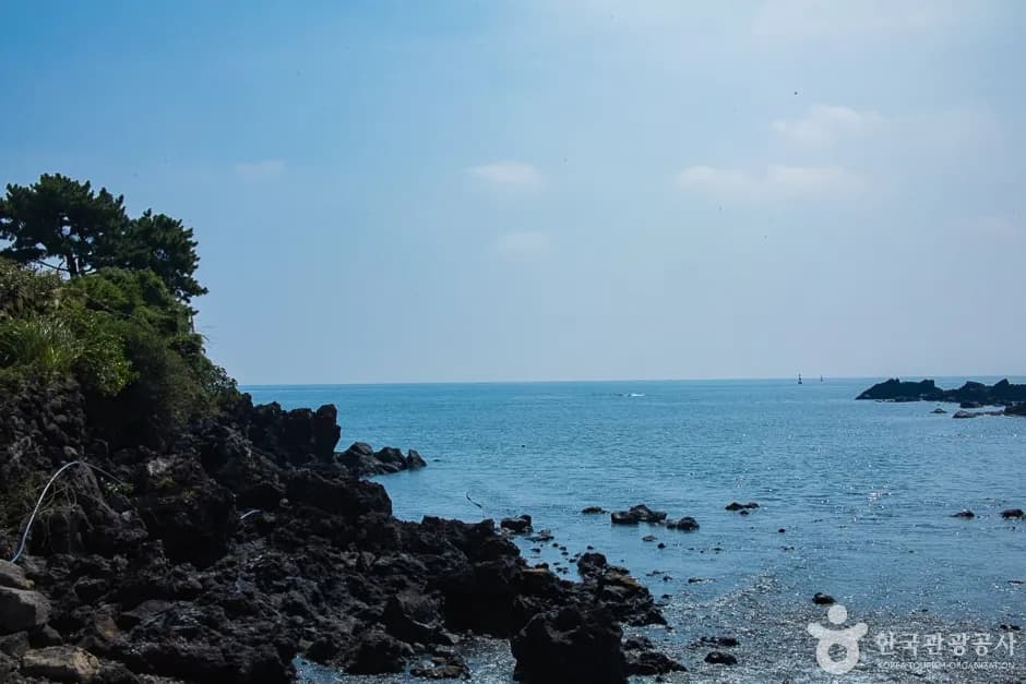 Rocky volcanic coastline by the tidal islet of Seogeon-do in Seogwipo