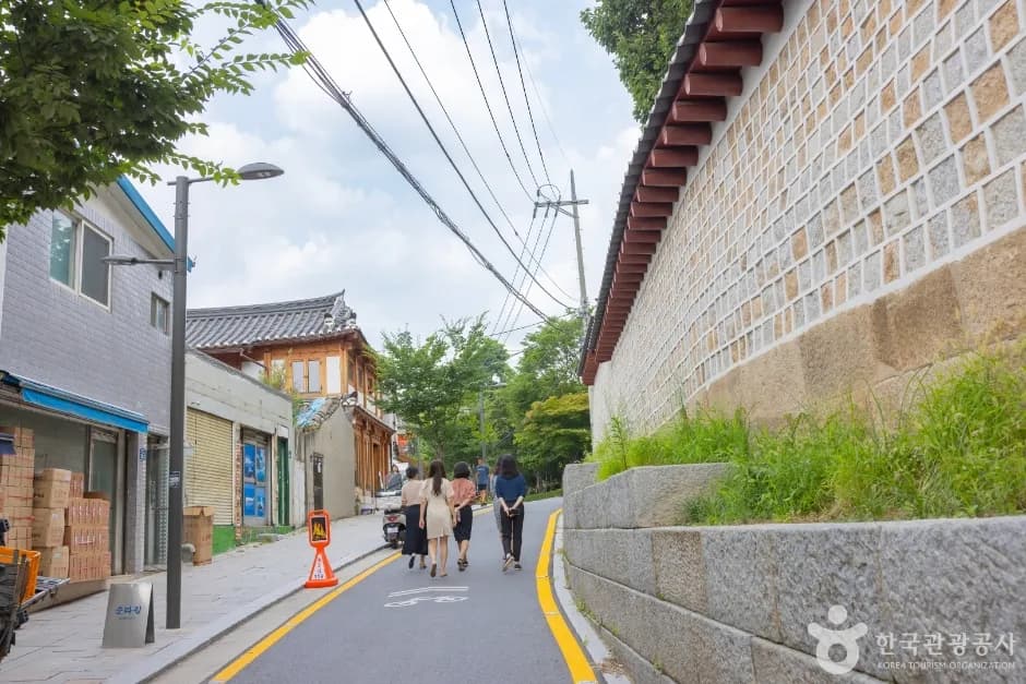 Visitors strolling the stone-walled Seosulla-gil lane