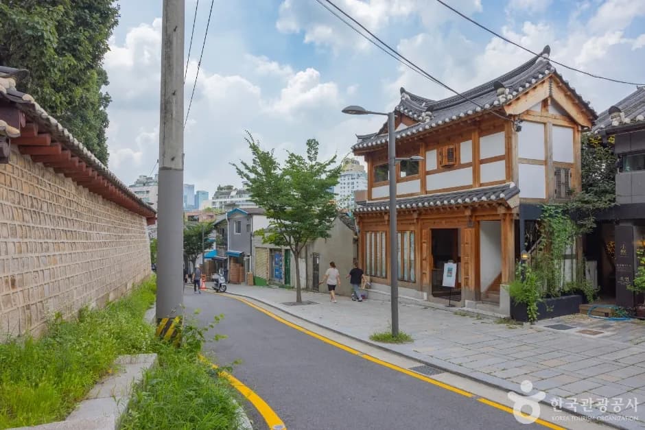 Hanok and lane on Seosulla-gil with the city beyond