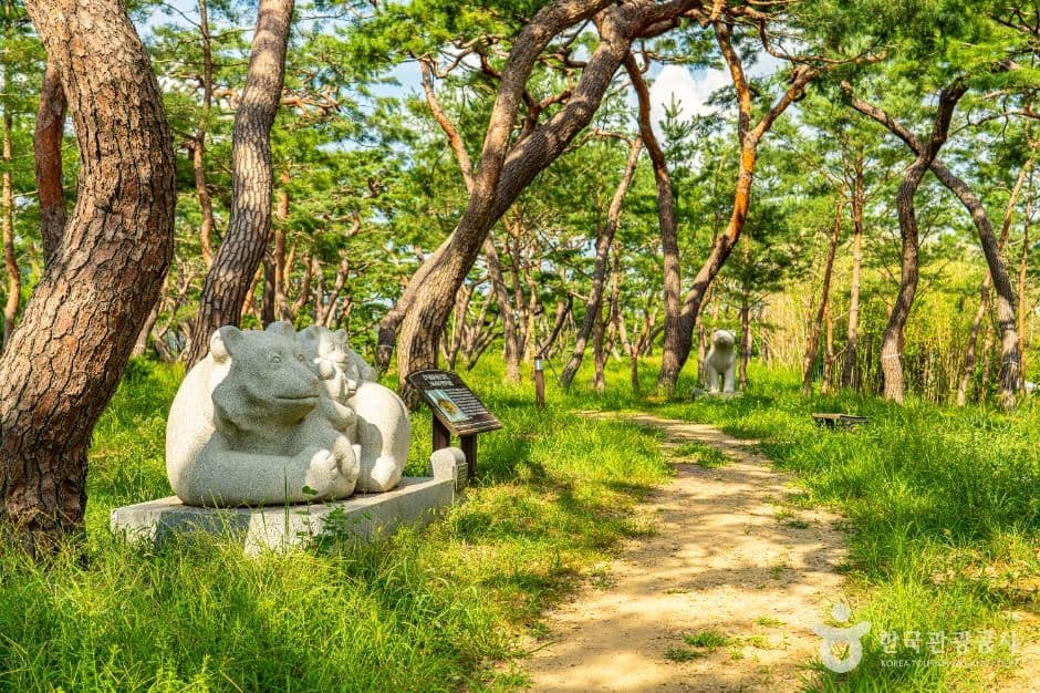 A stone monument among the pine trees at Gomanaru