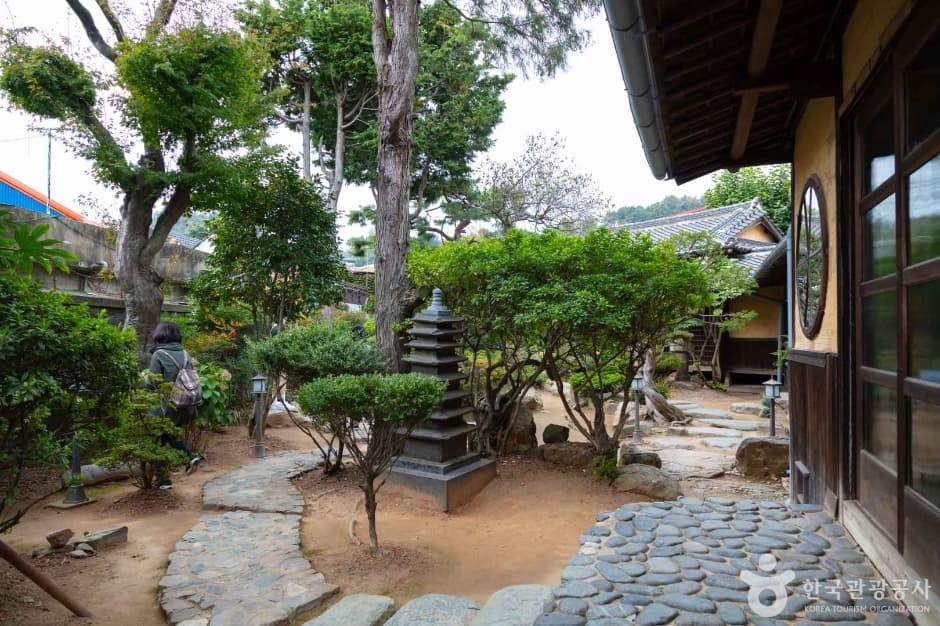 Stone-paved courtyard and landscaped garden of the Sinheung-dong Japanese-style house