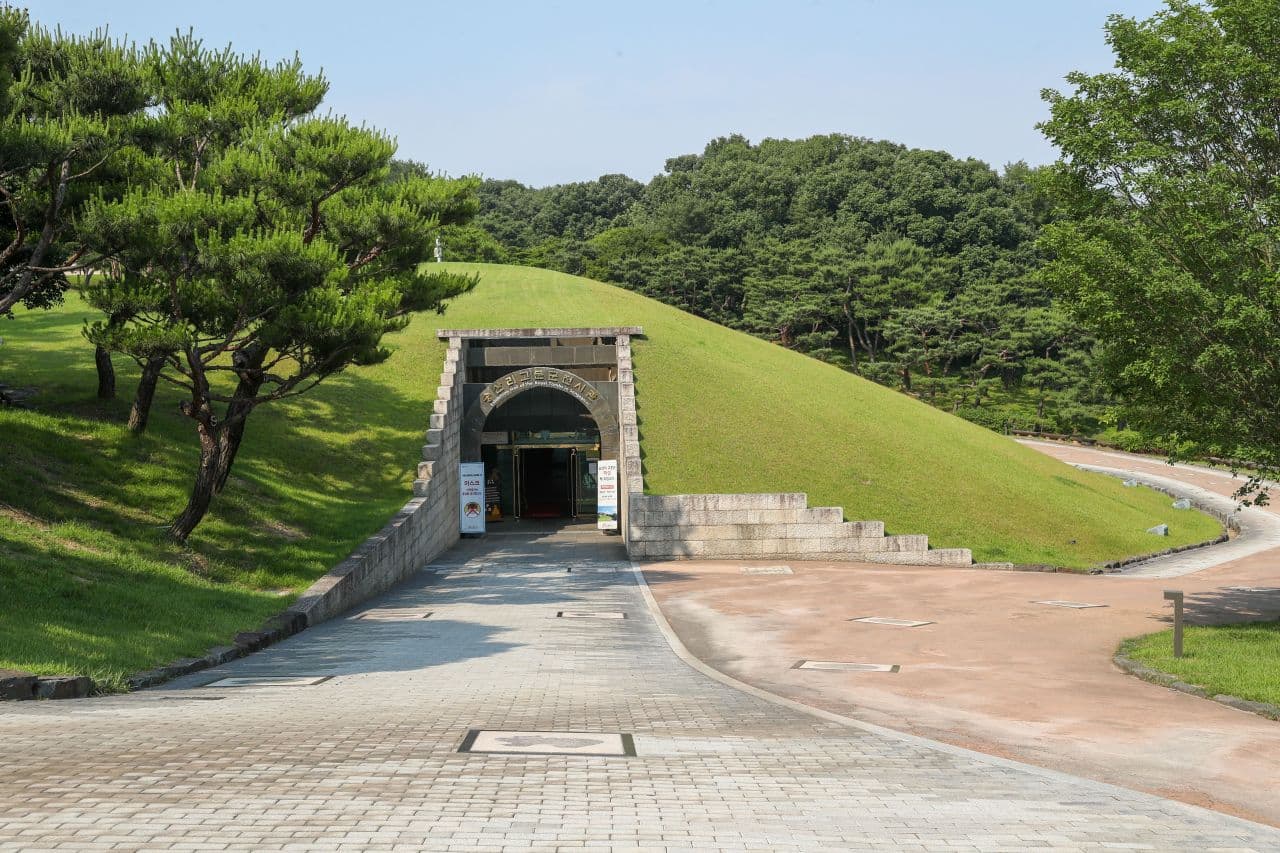 Grass-covered burial mound and stone entrance at the Royal Tombs at Songsan-ri in Gongju