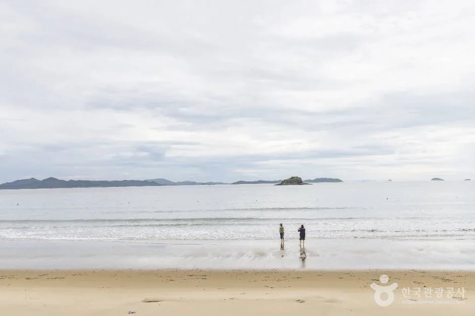 Calm water and an offshore islet at Baekgil Beach, Sinan