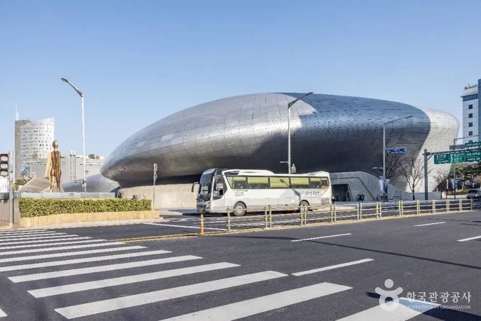 Dongdaemun Design Plaza illuminated at night with its curved architecture