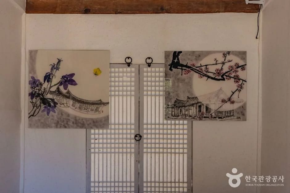 Ink paintings of camellia and plum blossoms on a hanji wall inside Kim Whanki House, Sinan