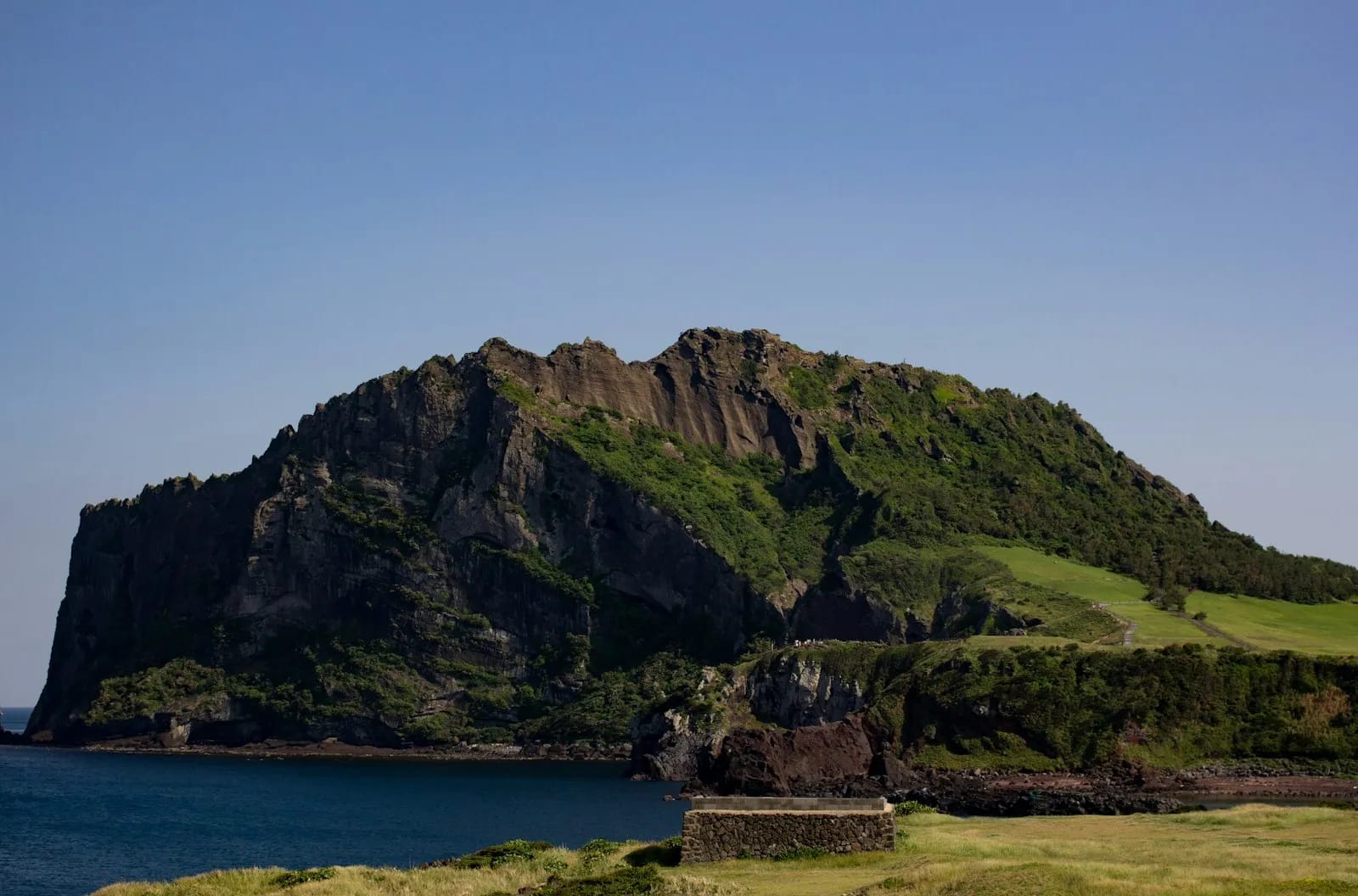 Seongsan Ilchulbong volcanic peak rising from the coastline of Jeju Island