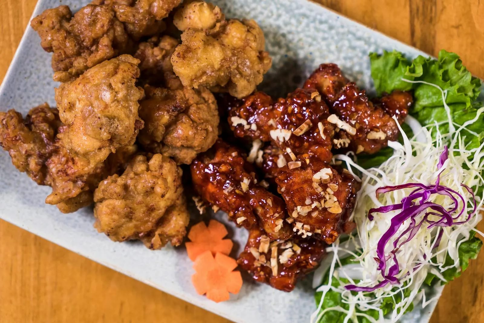 Korean fried chicken dakgangjeong served with fresh salad