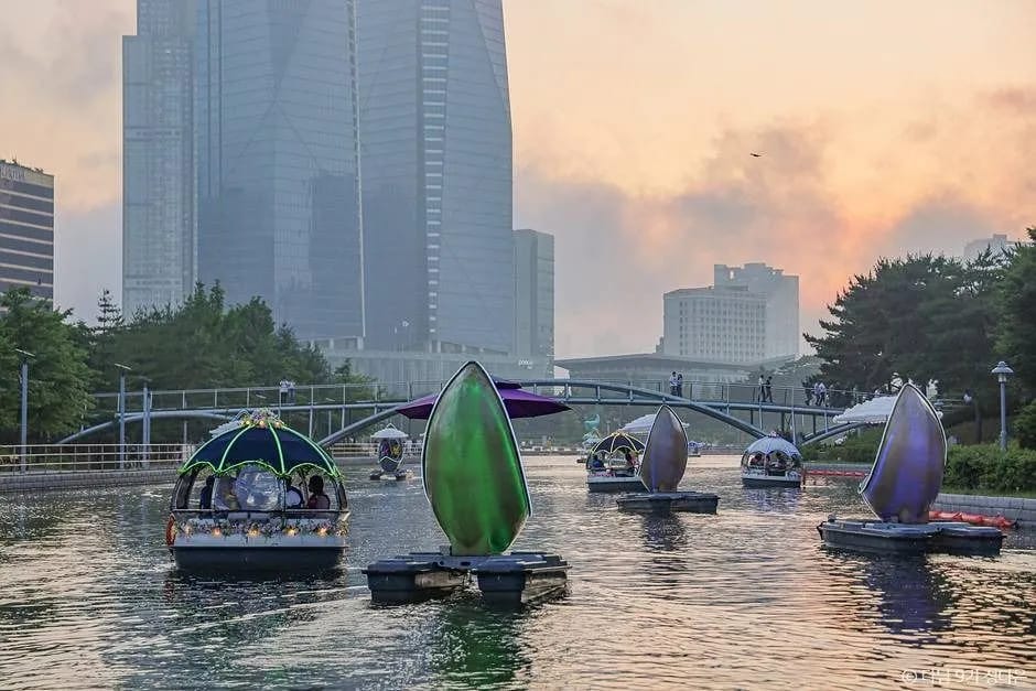 Decorative boats on the seawater canal at Songdo Central Park during golden hour
