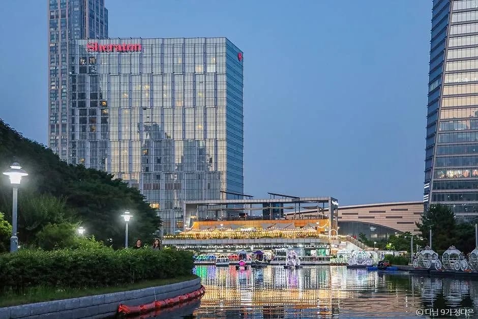 Songdo Central Park seawater canal with modern skyscrapers and Sonhwajeong Pavilion in Incheon