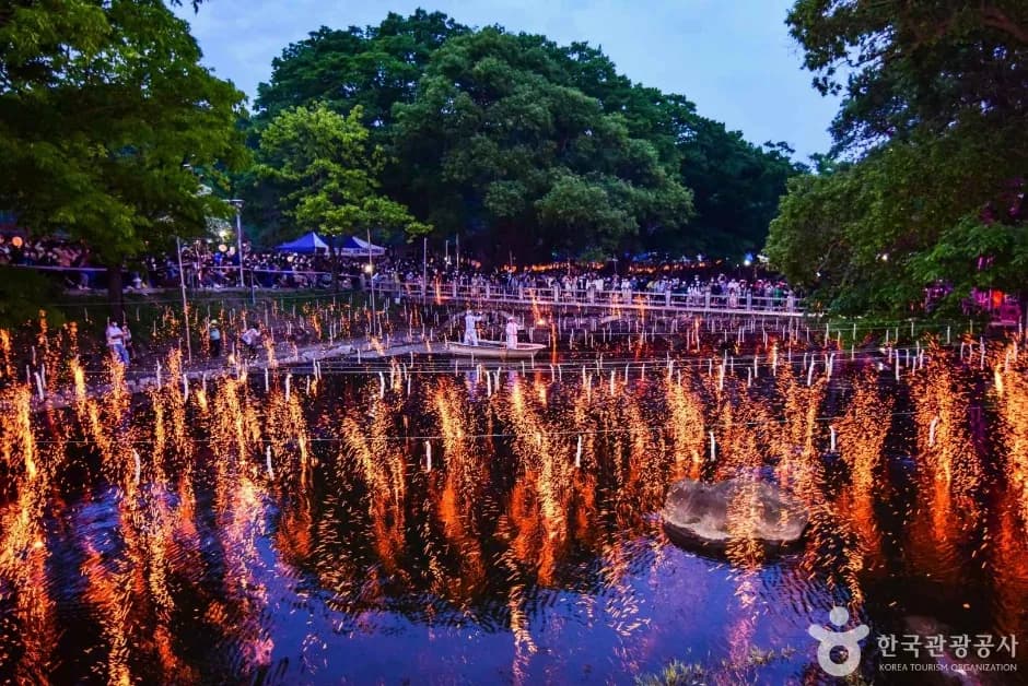Wide view of Haman Nakhwanori festival with hundreds of burning rods over the pond