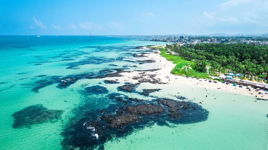 Turquoise waters of Hyeopjae Beach with Biyangdo island in the background, western Jeju