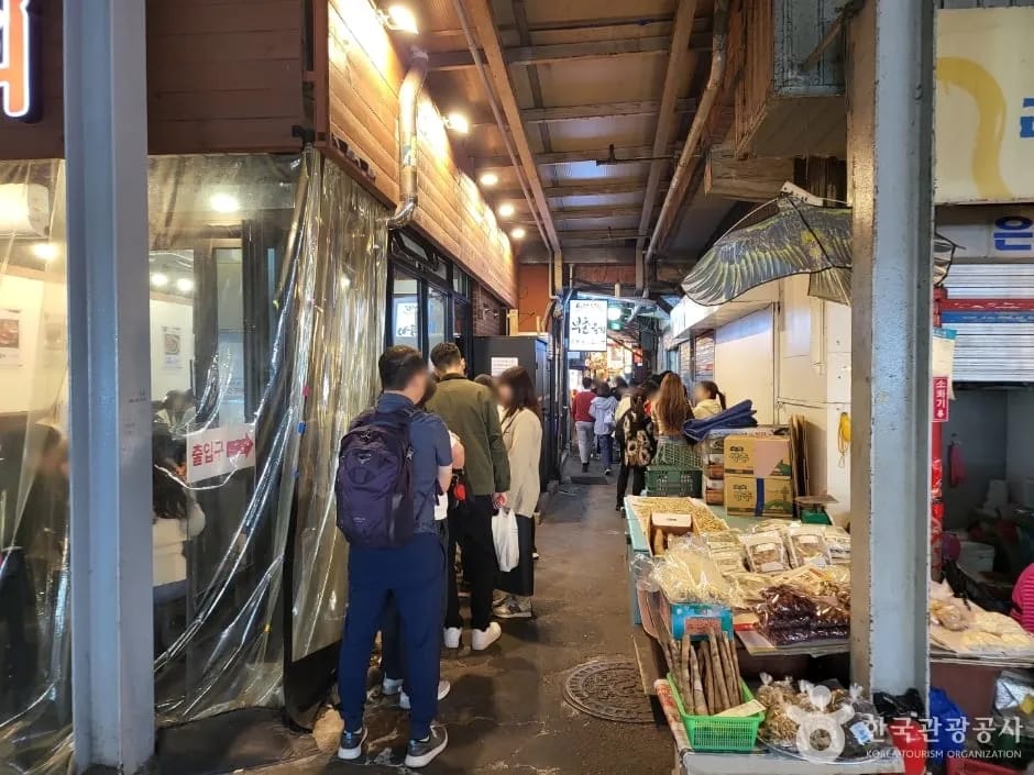 Korean street food stalls glowing at night in Seoul market